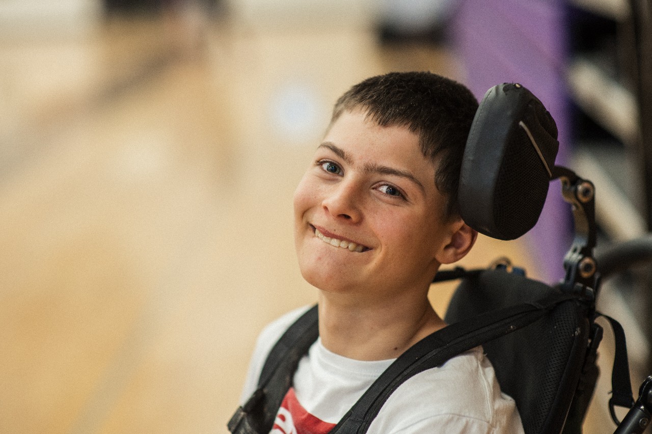 A student at Mountain Ridge Middle School smiles in his chair.